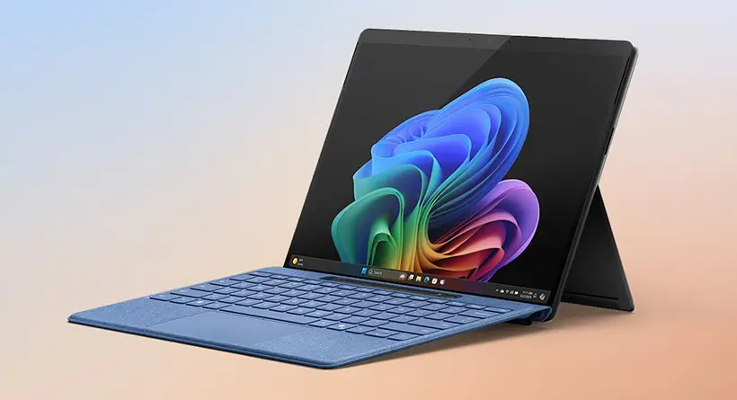 2-in-1 tablet with a blue keyboard cover, angled on a pastel gradient background showing colorful wallpaper on screen