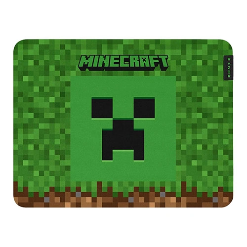 Minecraft-themed green mouse pad featuring a Creeper face on a pixelated grass background with a brown dirt border.